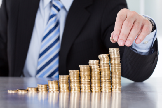 Close-up Of Businessman Stacking Coins