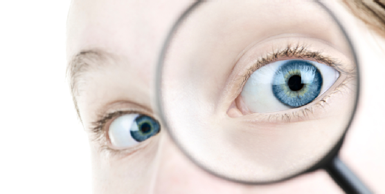 Eye looking thorough magnifying glass